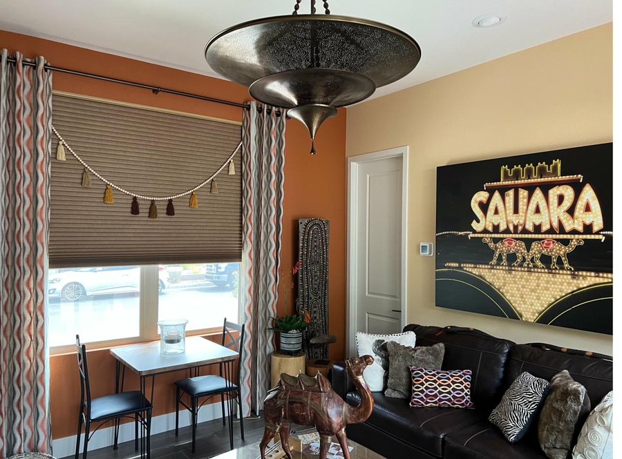 Layered honeycomb shades with drapery in a Las Vegas home by Moonlight Window Fashions